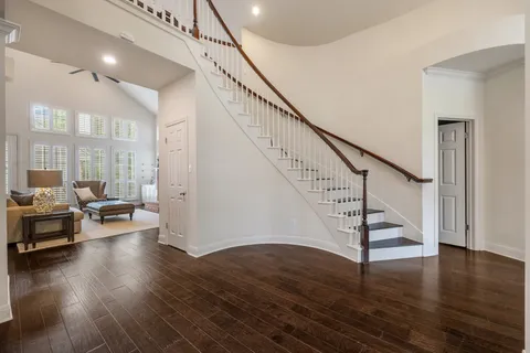 a view of entryway and hall with wooden floor