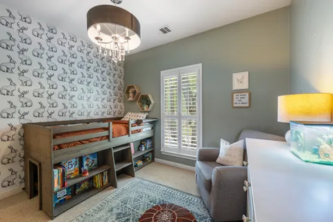 a living room with furniture and a bookshelf