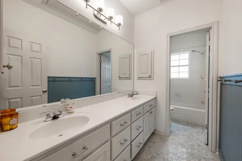 a bathroom with a double vanity sink double and mirror