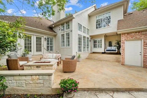 a view of a patio with couches table and chairs and potted plants