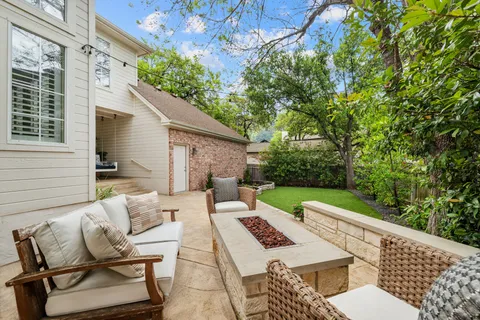 a view of backyard of house with seating area