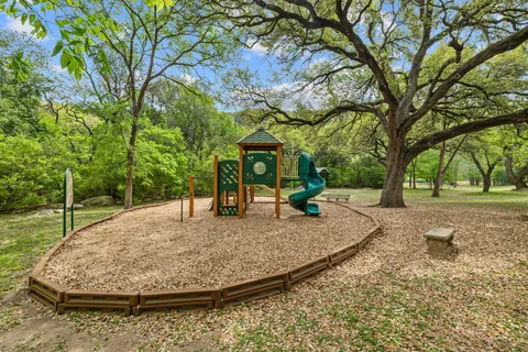 a view of a backyard with large trees