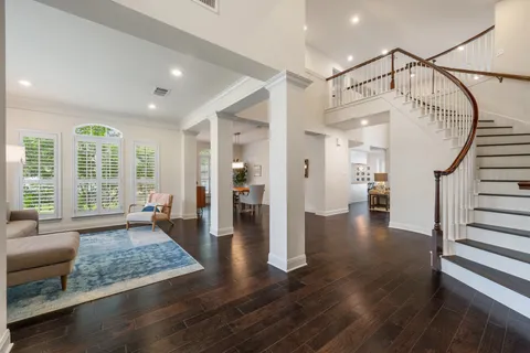 a living room with furniture and wooden floor
