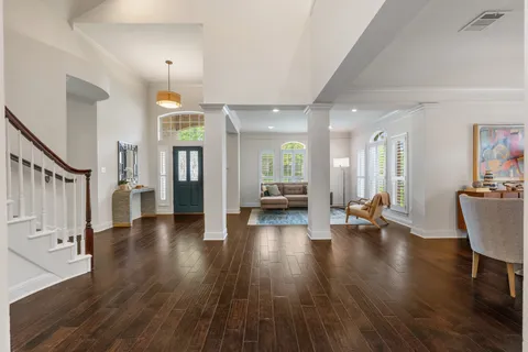 a living room with furniture and a wooden floor