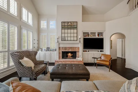 a living room with furniture fireplace and flat screen tv