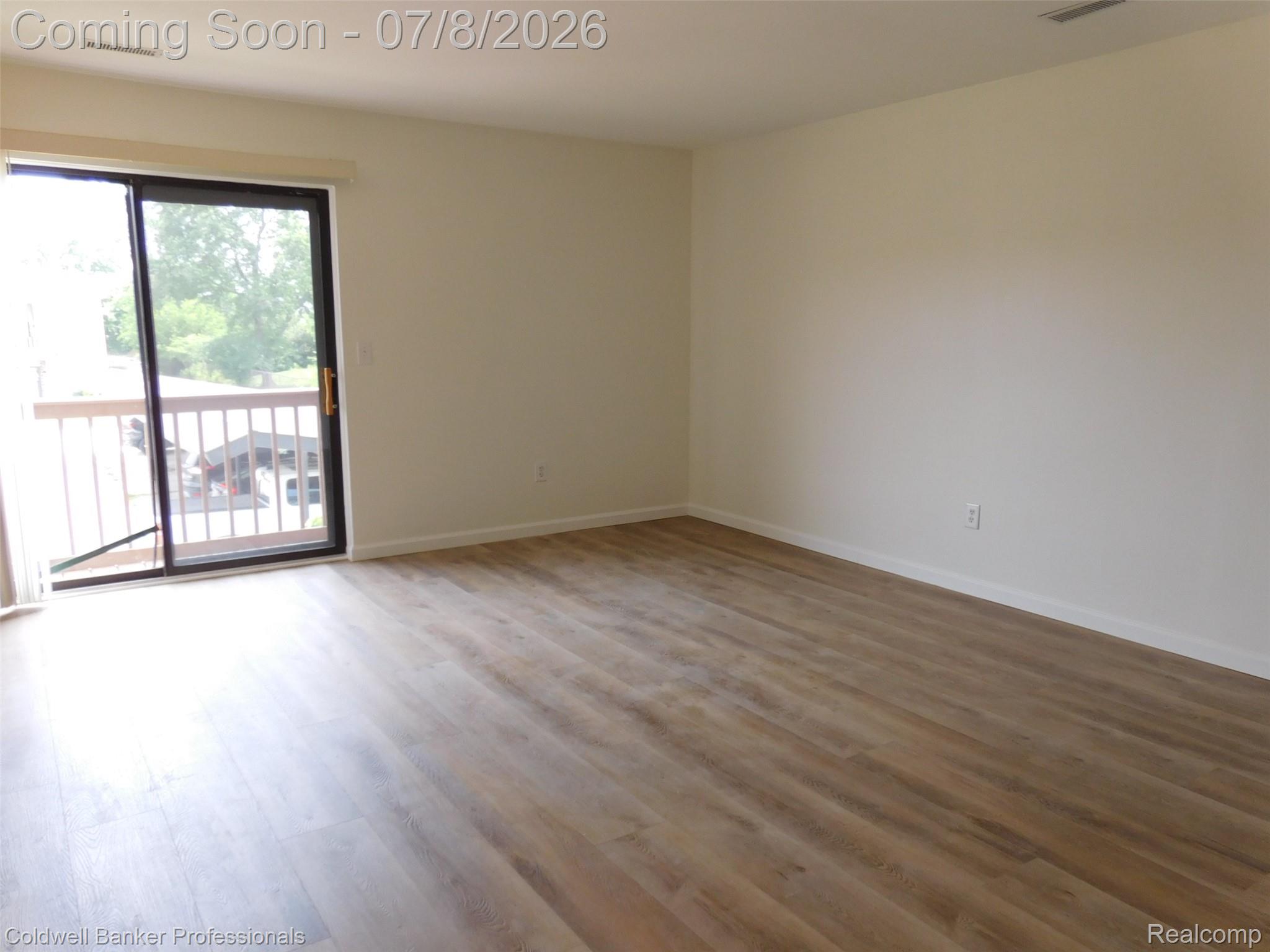 284 East 13 Mile Road Madison Heights, MI 48071 - Photo 5 of 21 Spacious room featuring wood-finish flooring, light-toned walls, and white trim