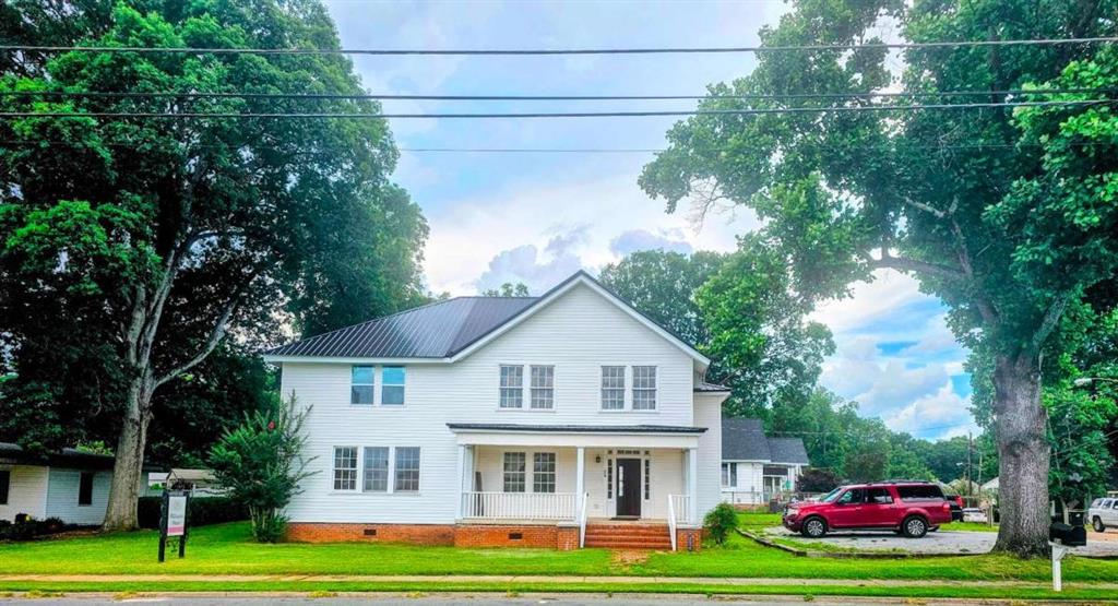 354 South Main Street Thomaston, GA 30286 - Photo 1 of 24 a view of white house with a big yard and large trees