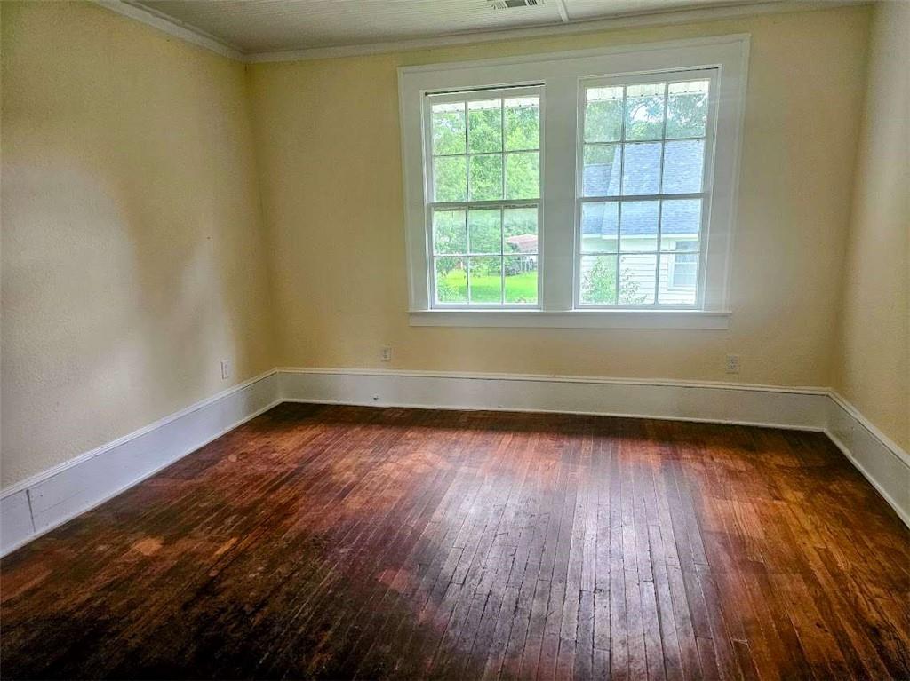 354 South Main Street Thomaston, GA 30286 - Photo 13 of 24 an empty room with wooden floor and windows