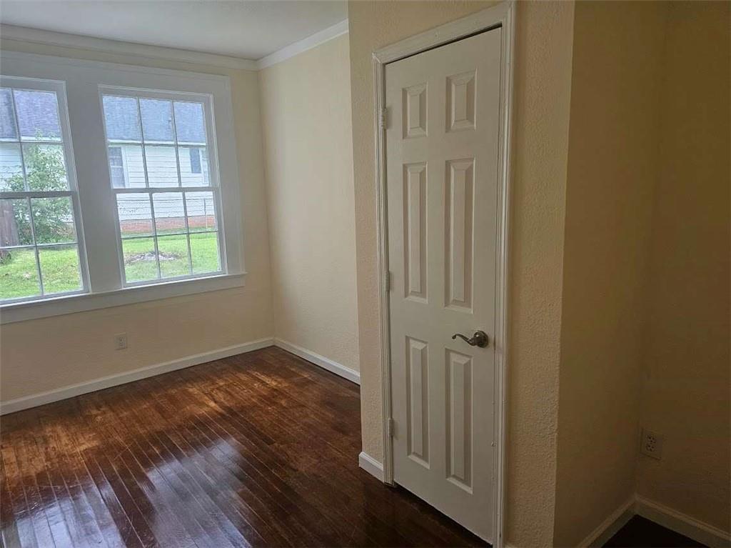 354 South Main Street Thomaston, GA 30286 - Photo 18 of 24 an empty room with wooden floor and windows