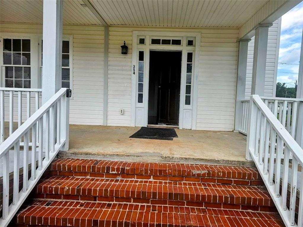 354 South Main Street Thomaston, GA 30286 - Photo 2 of 24 a view of balcony with wooden floor and stairs