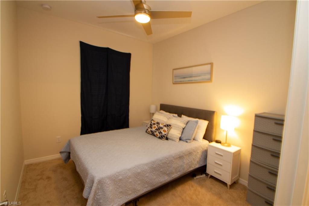 1241 Enbrook Loop Naples, FL 34114 - Photo 11 of 50 a bedroom with a bed and a ceiling fan