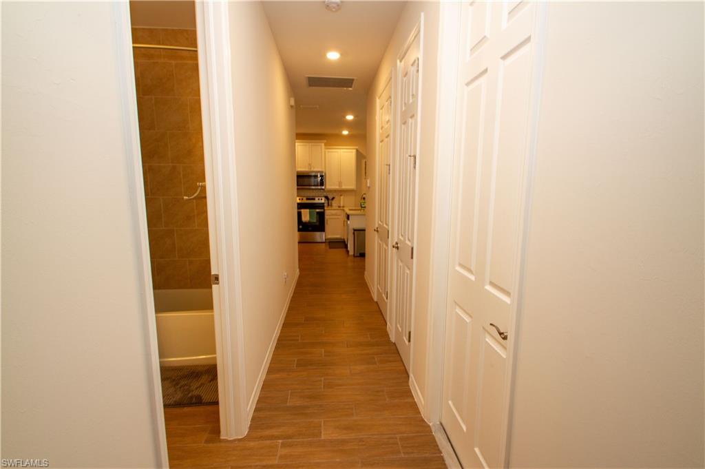 1241 Enbrook Loop Naples, FL 34114 - Photo 12 of 50 a view of a hallway with a wooden floor