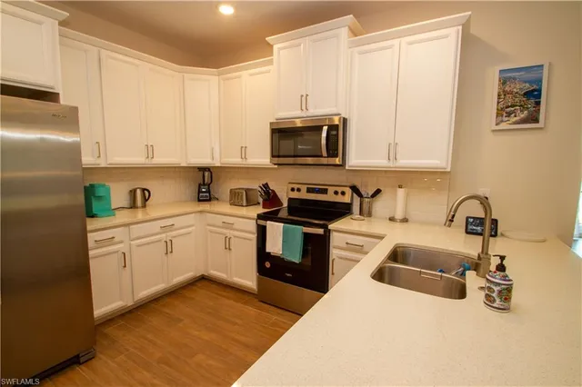 a kitchen with a sink stove and refrigerator