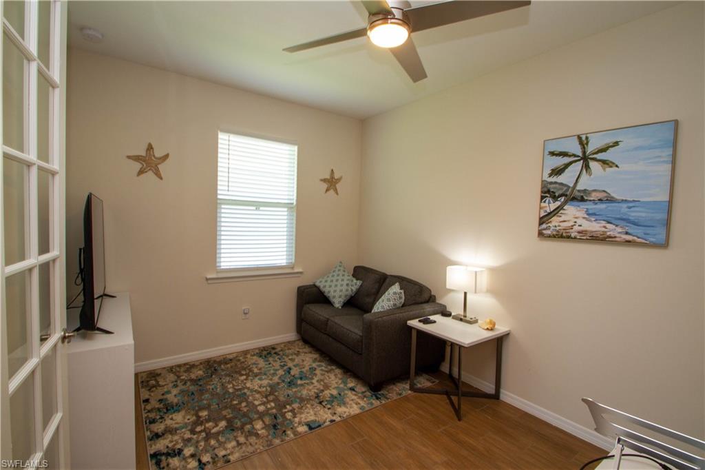 1241 Enbrook Loop Naples, FL 34114 - Photo 16 of 50 a living room with furniture and a flat screen tv