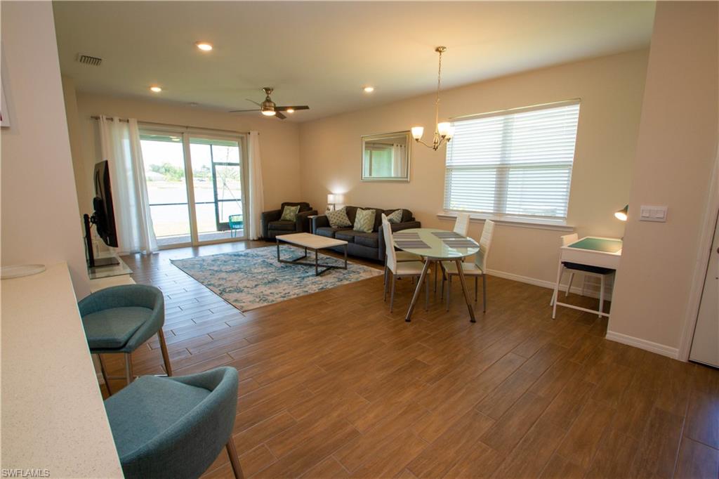1241 Enbrook Loop Naples, FL 34114 - Photo 20 of 50 a living room with furniture and a large window