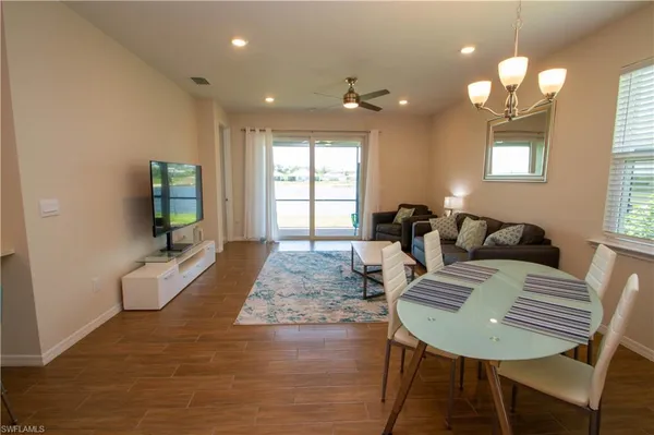 a living room with furniture and a chandelier