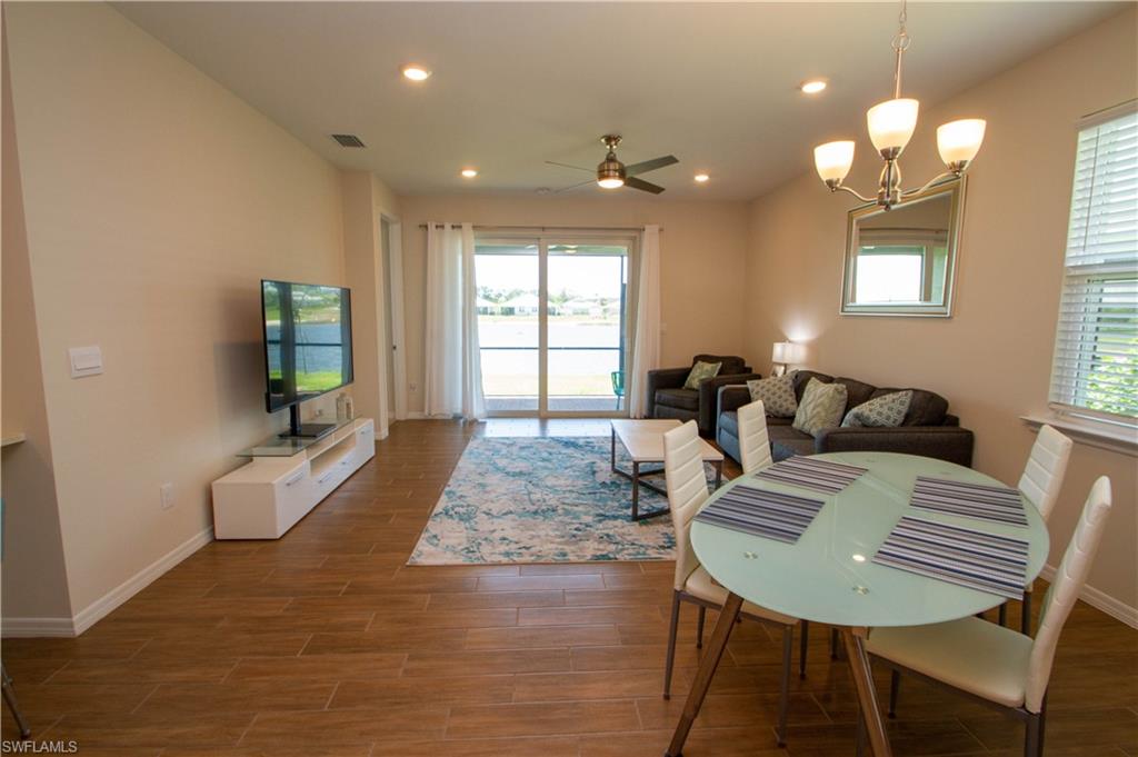 1241 Enbrook Loop Naples, FL 34114 - Photo 21 of 50 a living room with furniture and a chandelier