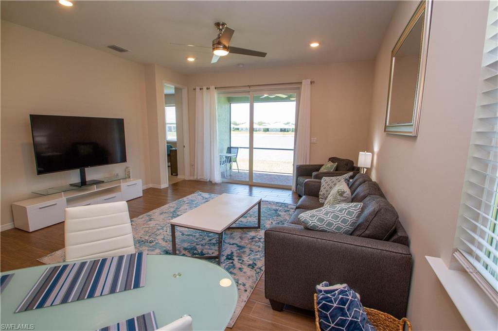 1241 Enbrook Loop Naples, FL 34114 - Photo 22 of 50 a living room with furniture and a flat screen tv