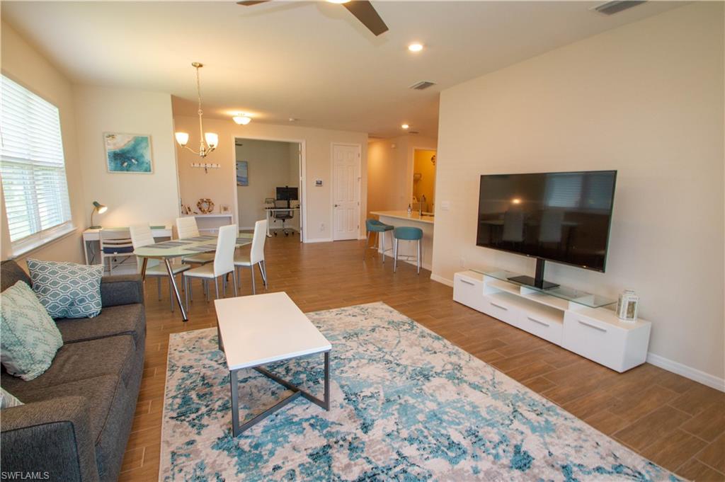 1241 Enbrook Loop Naples, FL 34114 - Photo 23 of 50 a living room with furniture and a flat screen tv