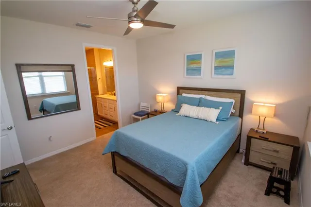 a bedroom with a bed and a tv on the dresser