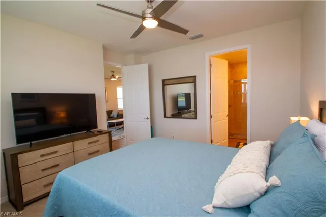a bedroom with furniture and a flat screen tv