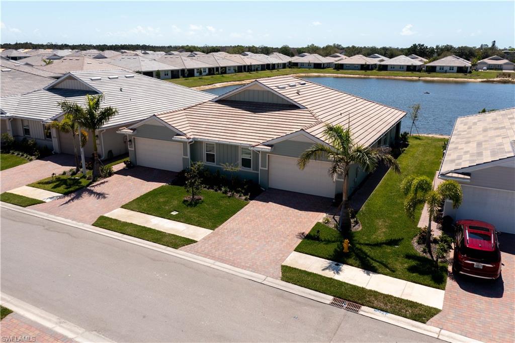 1241 Enbrook Loop Naples, FL 34114 - Photo 38 of 50 an aerial view of a house with swimming pool and ocean view