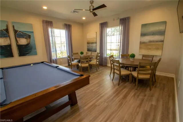 a view of a swimming pool with lawn chairs and a fire pit