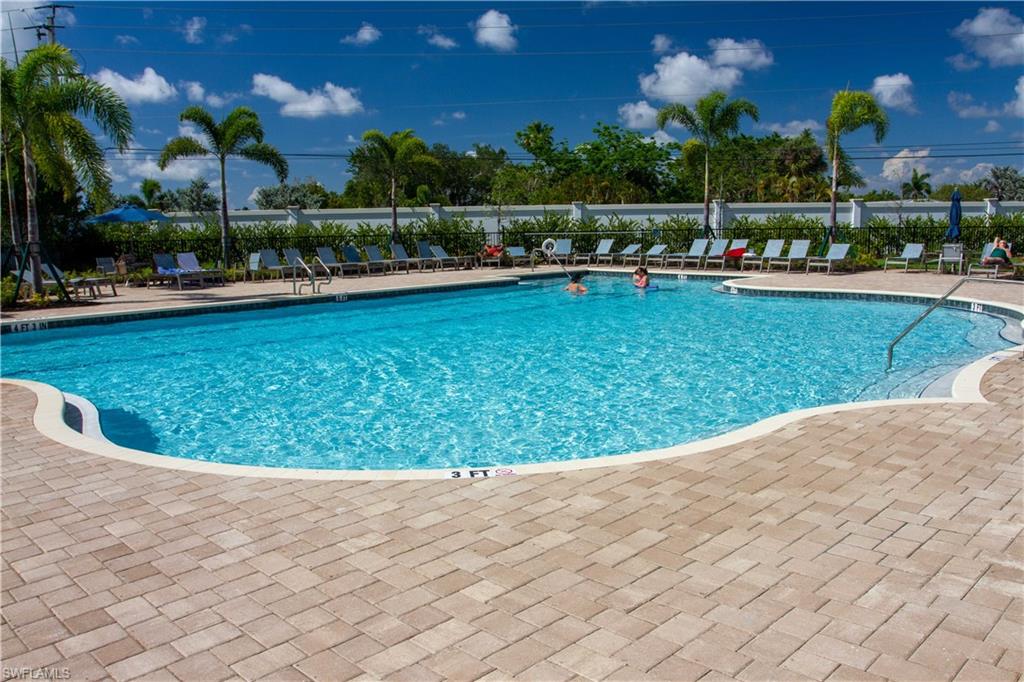 1241 Enbrook Loop Naples, FL 34114 - Photo 47 of 50 a view of a swimming pool with lawn chairs and a fire pit