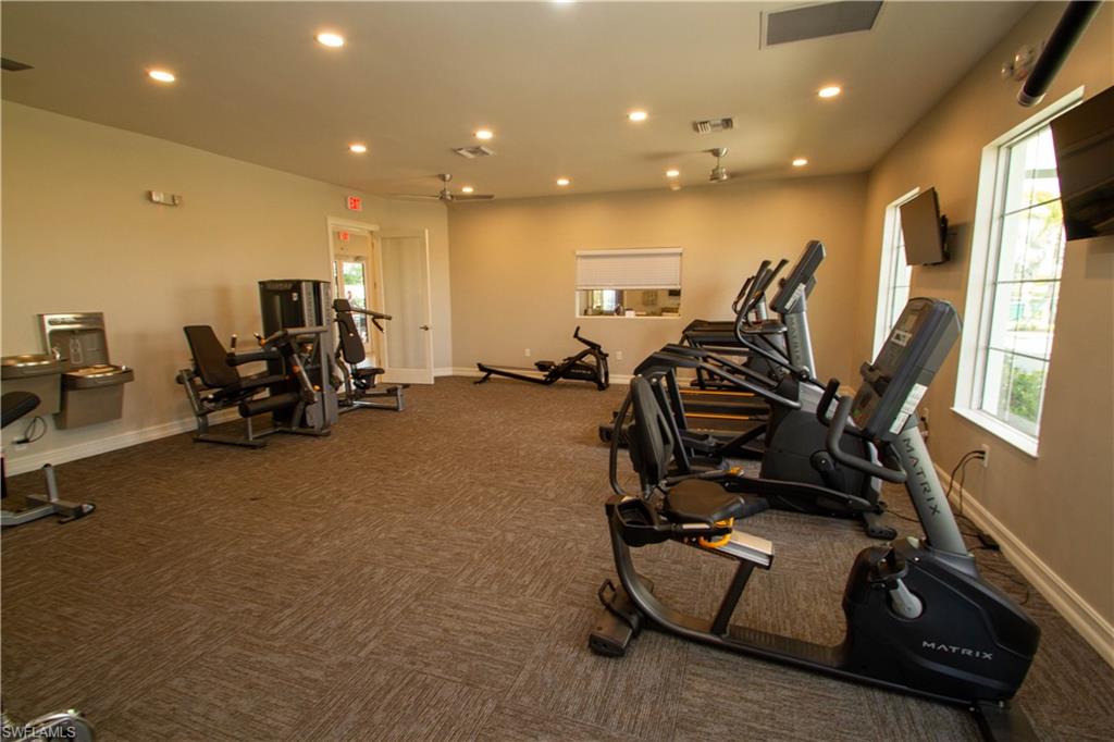 1241 Enbrook Loop Naples, FL 34114 - Photo 48 of 50 a room with gym equipment and windows