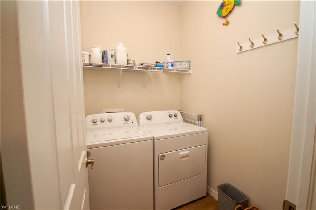 1241 Enbrook Loop Naples, FL 34114 - Photo 9 of 50 a utility room with dryer and washer