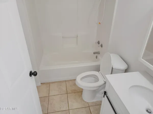 a white toilet sitting next to a bath tub