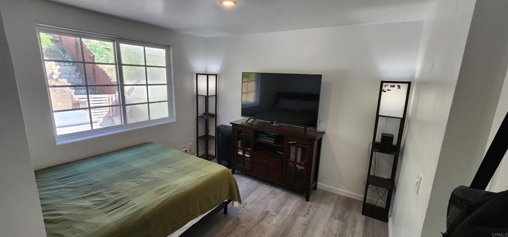 847 Raintree Place Vista, CA 92084 - Photo 10 of 14 a bedroom with a bed and a flat tv screen on the dresser