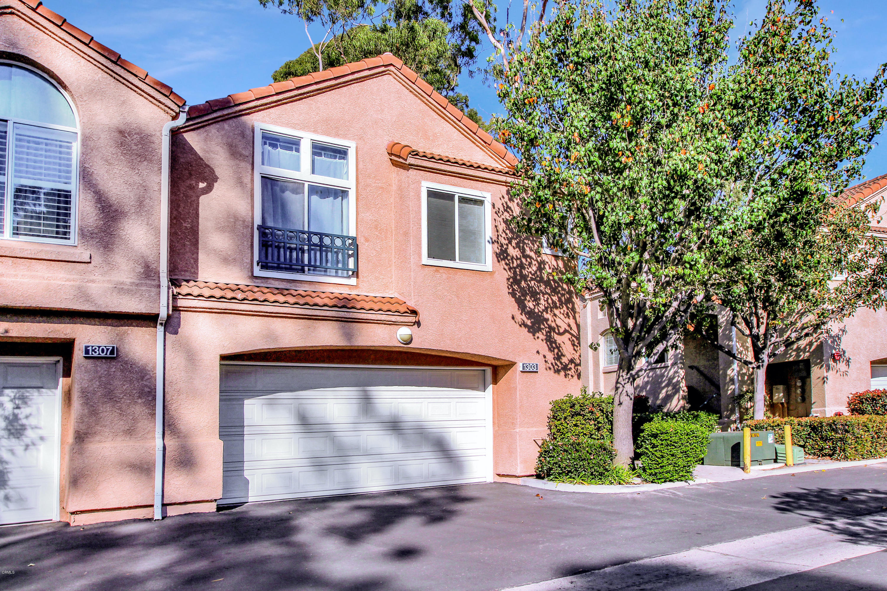 1303 Lost Point Lane Oxnard, CA 93030 - Photo 3 of 28 a front view of a house with a yard and garage