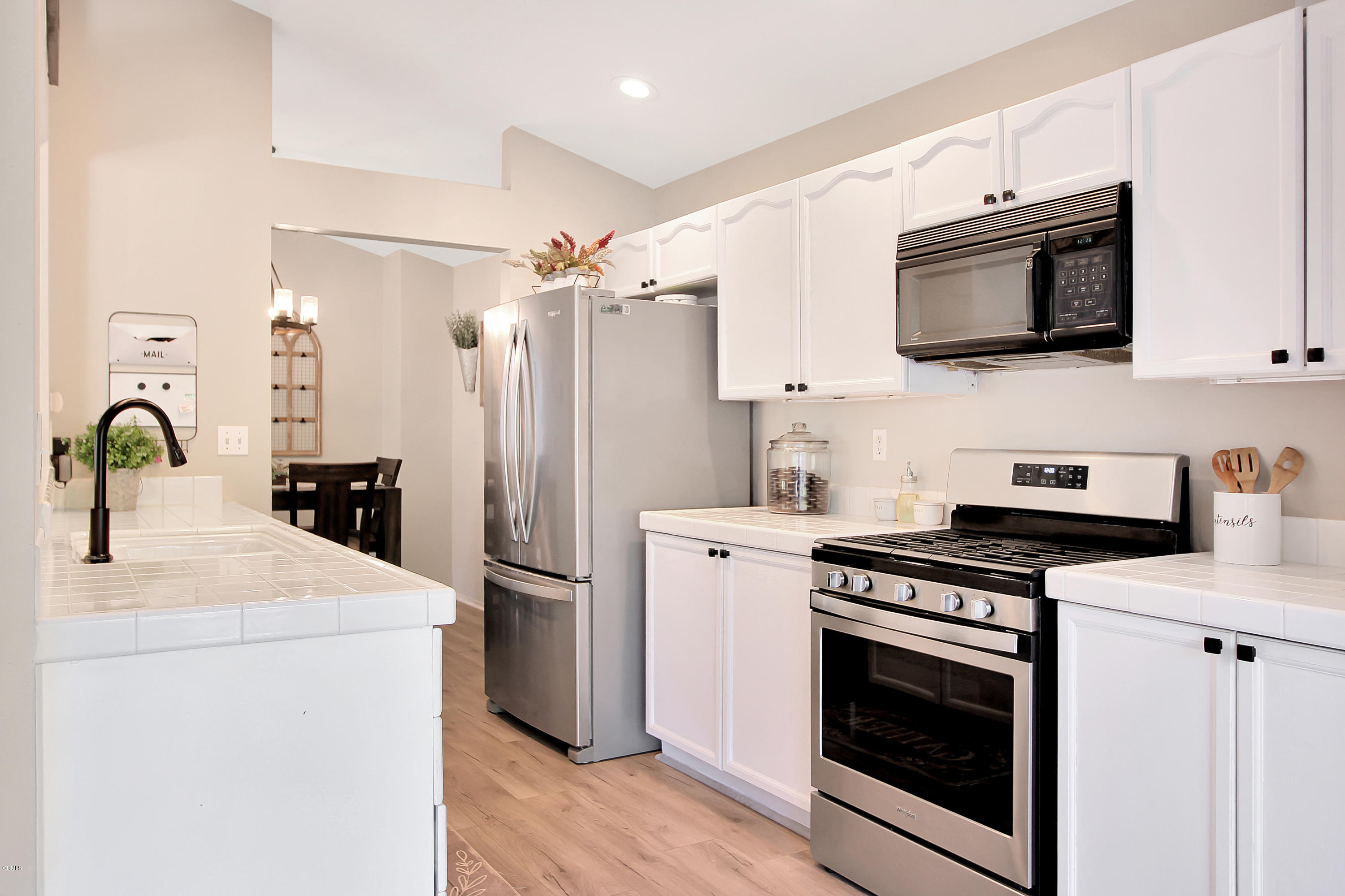 1303 Lost Point Lane Oxnard, CA 93030 - Photo 6 of 28 a kitchen with stainless steel appliances a stove microwave and sink