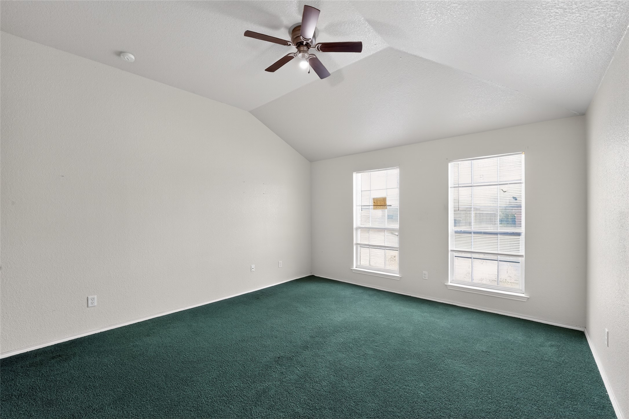 152 Eagle Drive Luling, TX 78648 - Photo 15 of 31 an empty room with windows and fan