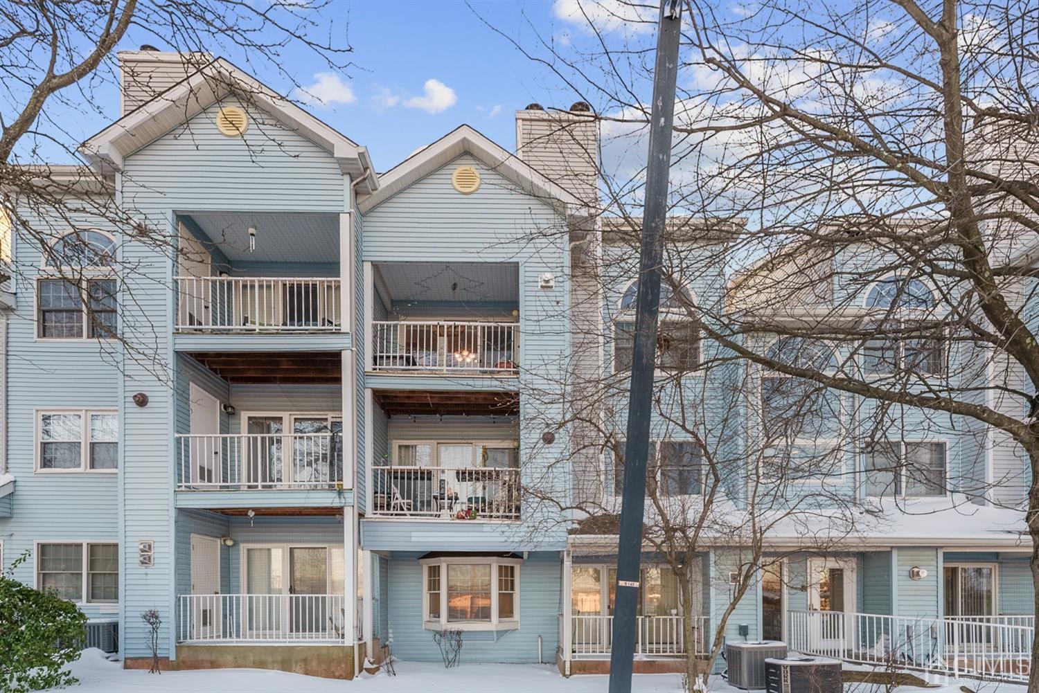134 Edpas Road New Brunswick, NJ 08901 - Photo 2 of 16 a front view of a residential apartment building with a yard