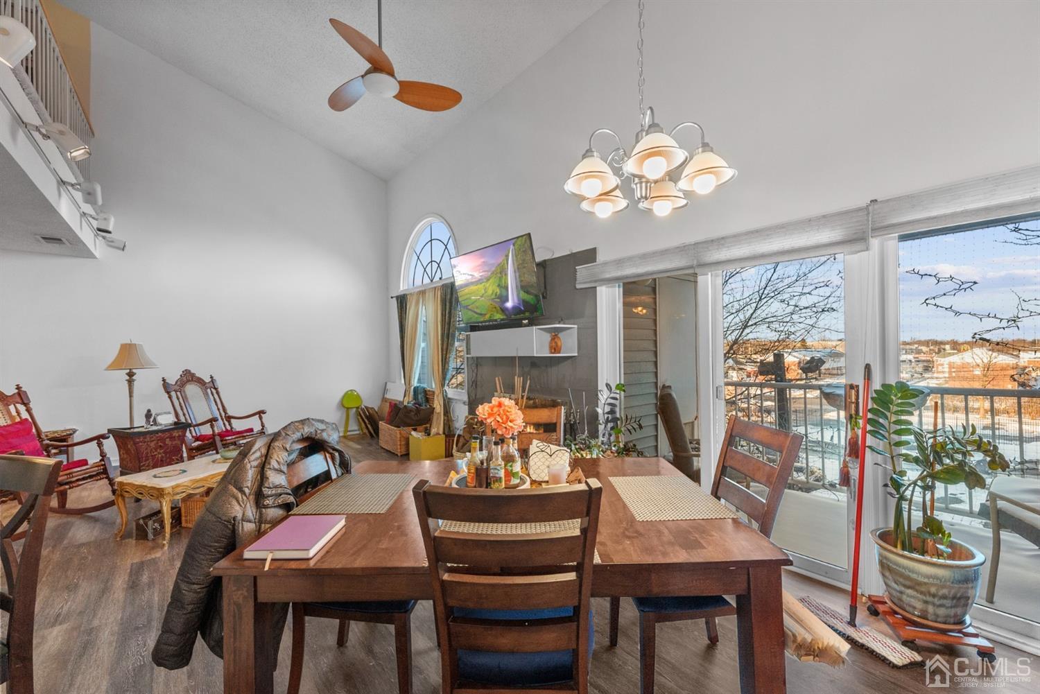 134 Edpas Road New Brunswick, NJ 08901 - Photo 6 of 16 a view of a dining room with furniture a chandelier windows and wooden floor