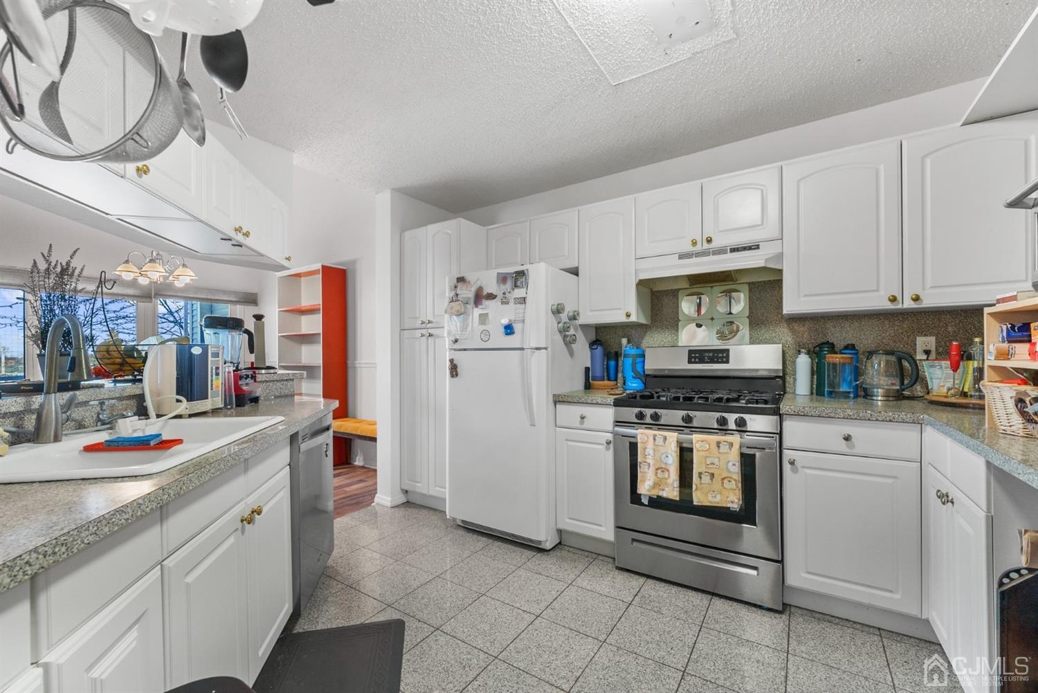 134 Edpas Road New Brunswick, NJ 08901 - Photo 7 of 16 a kitchen with cabinets and stainless steel appliances