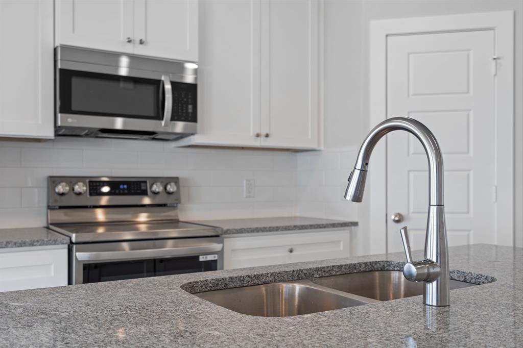 227 Faith Lane Tioga, TX 76271 - Photo 11 of 26 a kitchen with a stove and a microwave