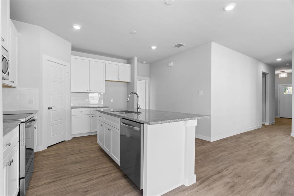 227 Faith Lane Tioga, TX 76271 - Photo 13 of 26 a kitchen with a stove a sink and a refrigerator