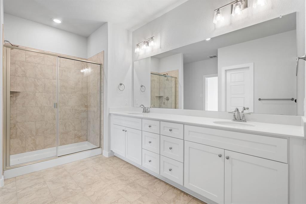 227 Faith Lane Tioga, TX 76271 - Photo 18 of 26 a bathroom with double sink and a mirror