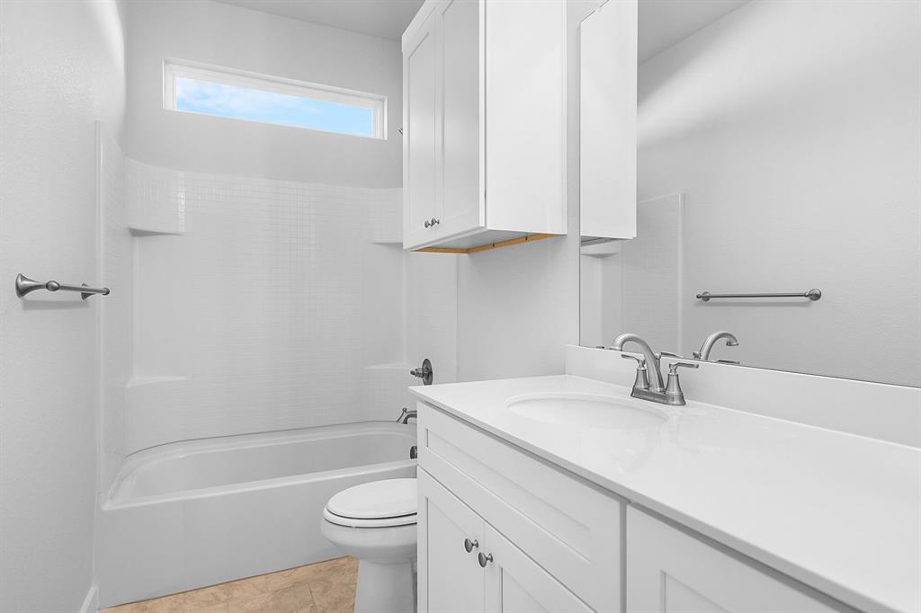 227 Faith Lane Tioga, TX 76271 - Photo 21 of 26 a bathroom with a sink a toilet and bathtub