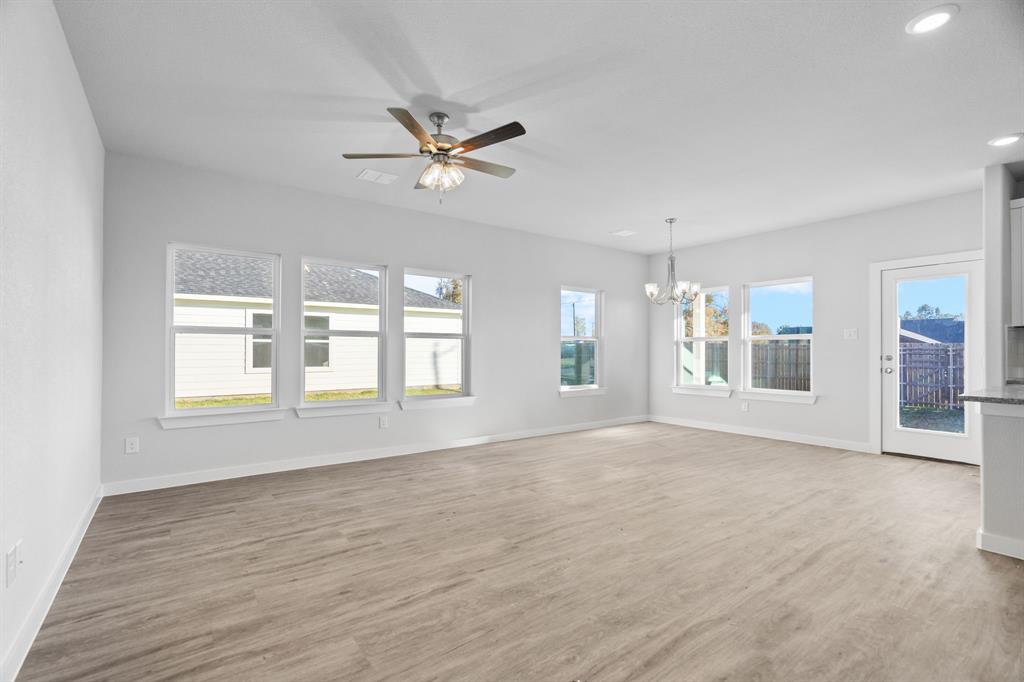 227 Faith Lane Tioga, TX 76271 - Photo 5 of 26 a view of an empty room with a window and wooden floor