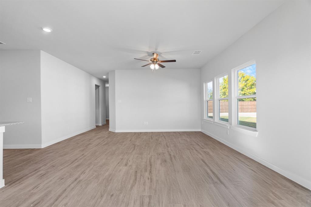 227 Faith Lane Tioga, TX 76271 - Photo 6 of 26 wooden floor in an empty room with a window