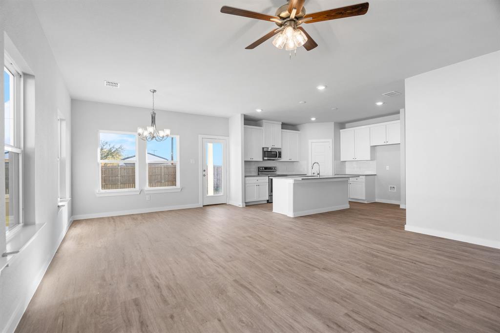 227 Faith Lane Tioga, TX 76271 - Photo 8 of 26 a view of a kitchen with a sink and dishwasher a refrigerator with wooden floor