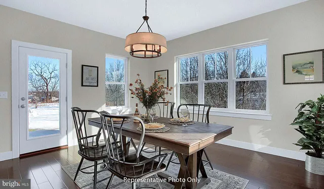 a view of a dining room with furniture window and wooden floor