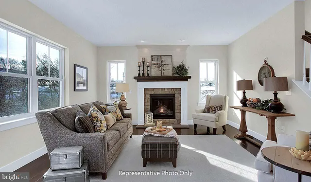 a living room with furniture a fireplace and window