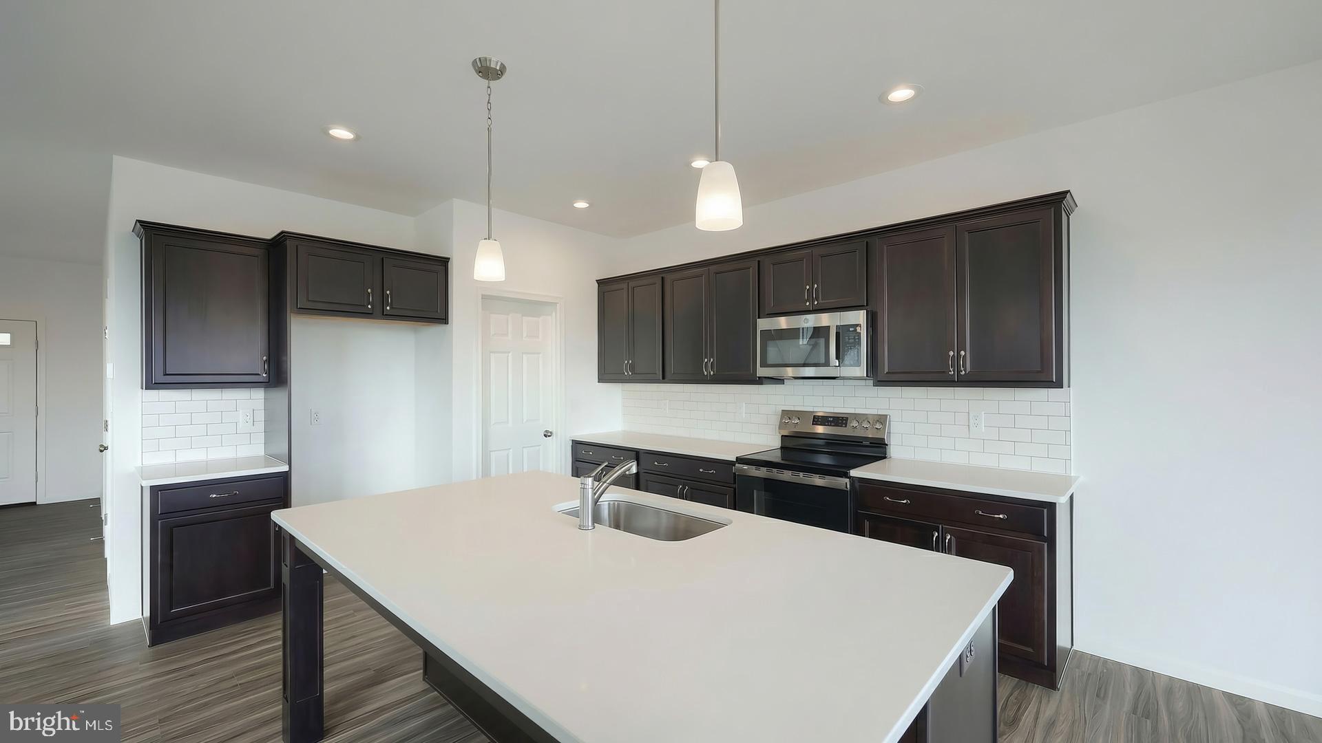 217 Copper Ridge Drive Newmanstown, PA 17073 - Photo 7 of 30 a kitchen with a sink a microwave a stove and refrigerator