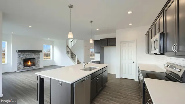 a kitchen that has a lot of cabinets and wooden floor