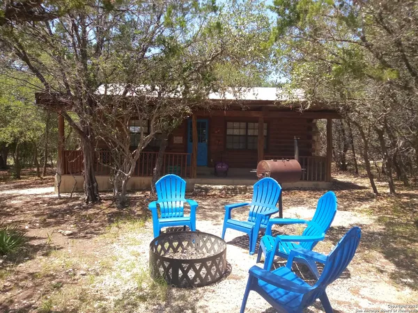 a view of a chairs and table in backyard